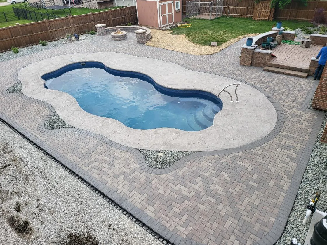 Pool deck with a resort-style paver surround in Shorewood, Illinois
