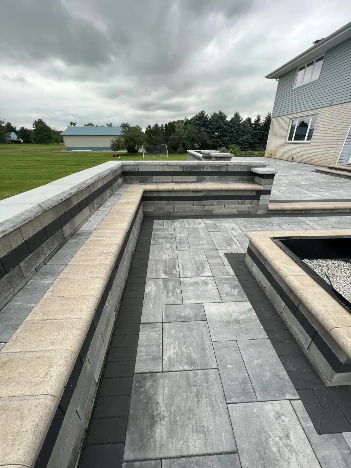 Curved paver patio with retaining wall detail in Shorewood, IL